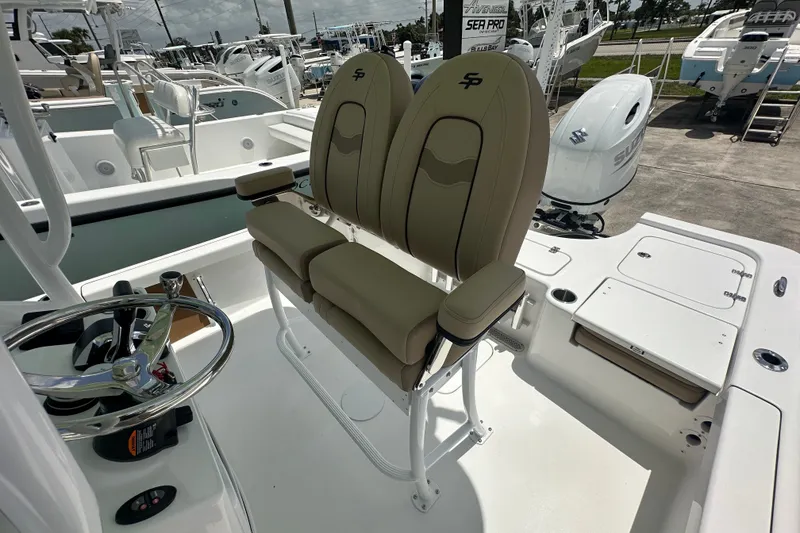 Slide: The Image of 2026 Sea Pro 230 Bay boat interior with dual seats and steering wheel. - 15