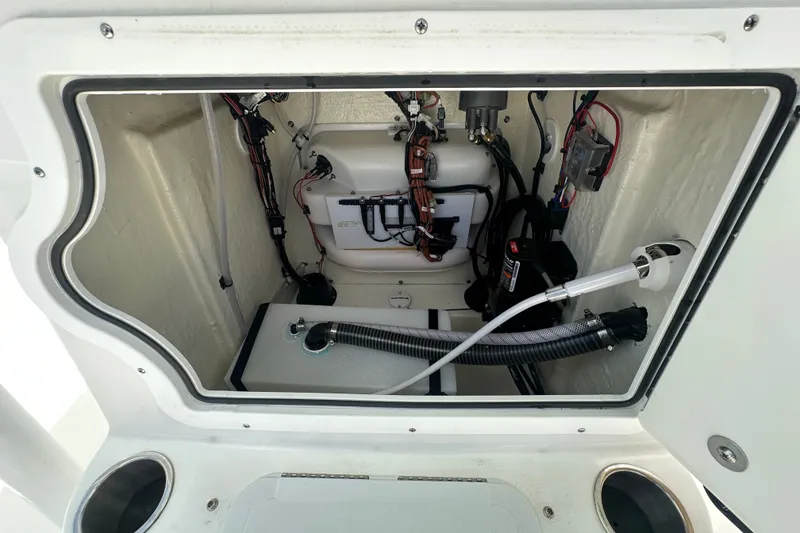 Slide: The Image of Interior view of 2026 Sea Pro 230 Bay boat's storage compartment with wiring and equipment. - 14