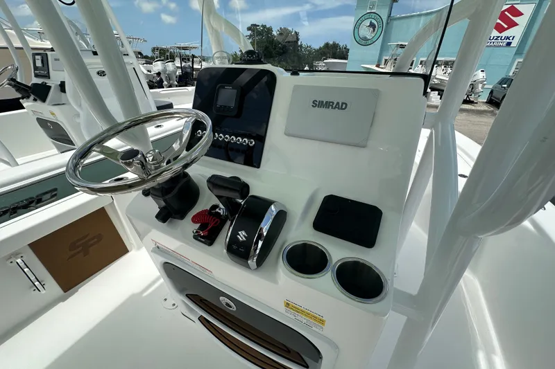 Slide: The Image of 2026 Sea Pro 230 Bay boat console with steering wheel and Simrad electronics. - 5