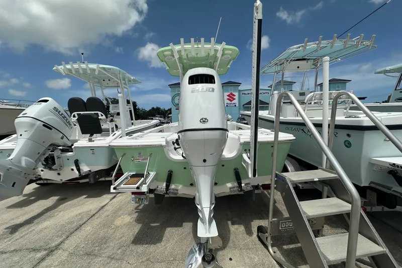 Slide: The Image of 2026 Sea Pro 230 Bay boat with Suzuki outboard motor, docked under clear skies. - 3