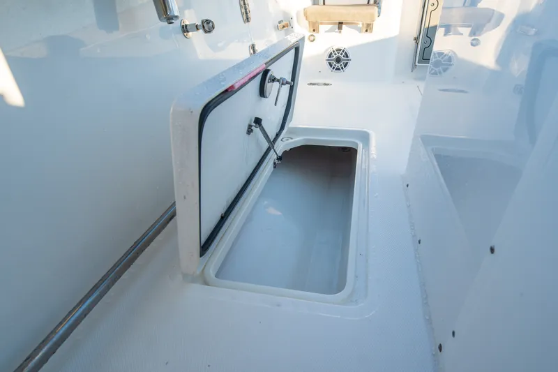 Slide: The Image of Open storage compartment on 2026 Sea Hunt Gamefish 30CB boat deck. - 28