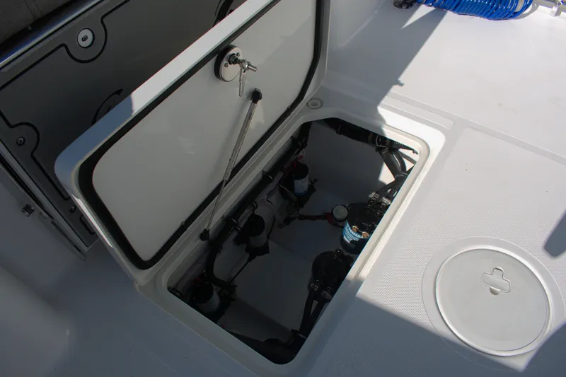Slide: The Image of Open hatch on 2026 Sea Hunt Gamefish 30CB boat, revealing internal components. - 12
