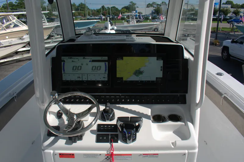 Slide: The Image of 2026 Sea Hunt Gamefish 30CB boat dashboard with navigation screens and steering wheel. - 7