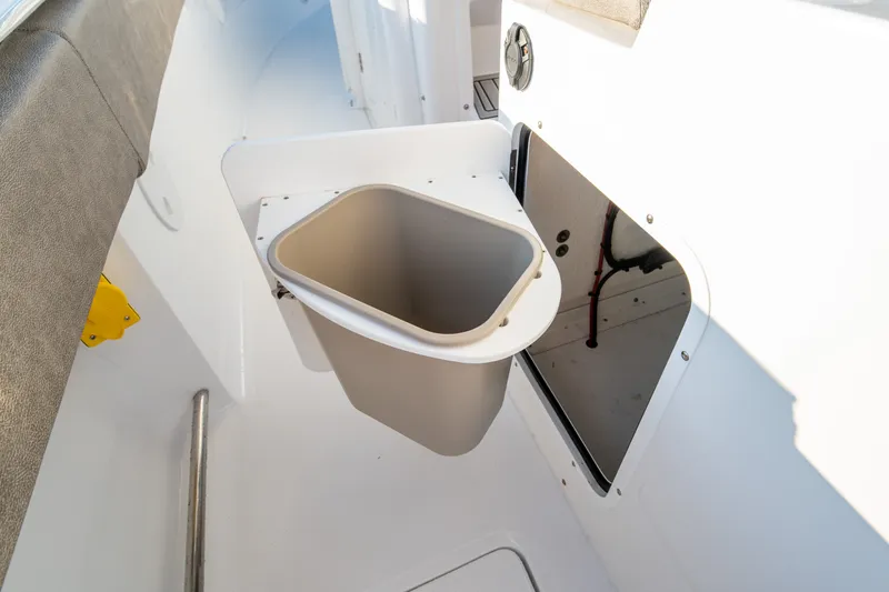 Slide: The Image of Interior view of 2026 Sea Hunt Gamefish 30CB boat with built-in trash compartment. - 25