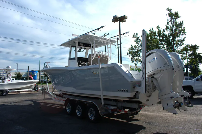 Slide: The Image of 2026 Sea Hunt Gamefish 30CB boat on trailer, parked outdoors. - 2