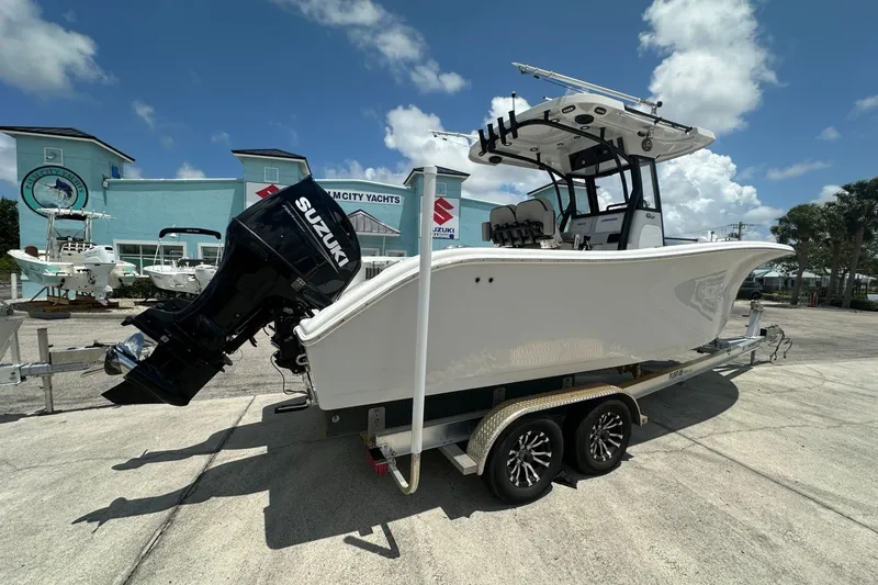Slide: The Image of 2024 Sea Pro 262 Center Console boat on trailer, featuring Suzuki outboard motor. - 3