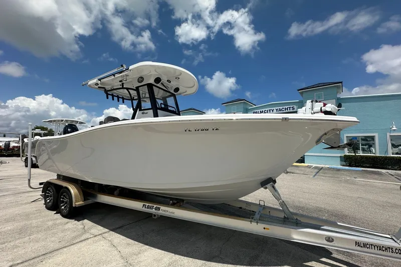 Slide: The Image of 2024 Sea Pro 262 Center Console boat on trailer at Palm City Yachts dealership. - 2