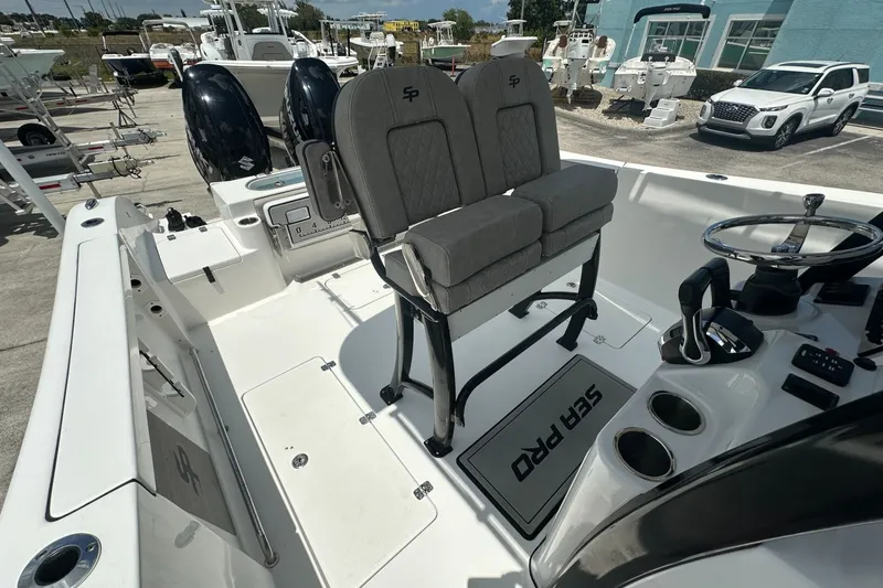 Slide: The Image of 2024 Sea Pro 262 Center Console boat interior with dual engines and modern helm controls. - 15