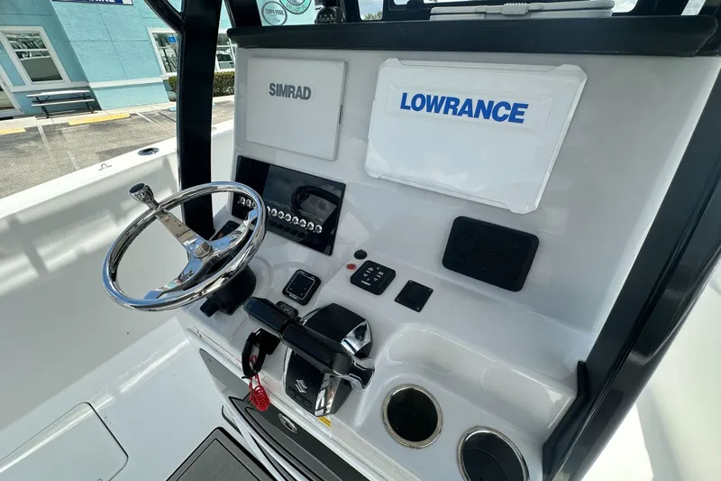Slide: The Image of 2024 Sea Pro 262 Center Console dashboard with Simrad and Lowrance displays. - 7