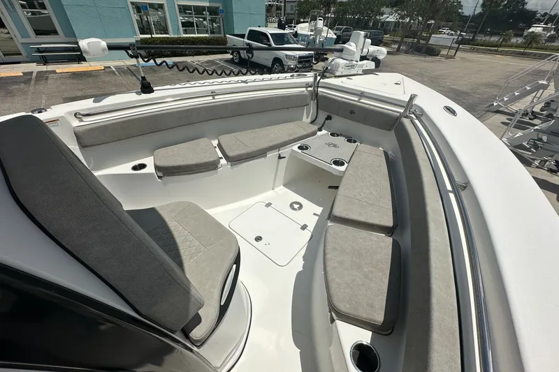 Slide: The Image of 2024 Sea Pro 262 Center Console boat interior with cushioned seating and cup holders. - 9
