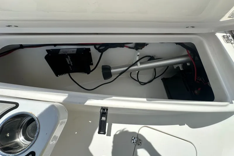 Slide: The Image of 2024 Sea Pro 262 Center Console storage compartment with wiring and equipment. - 12