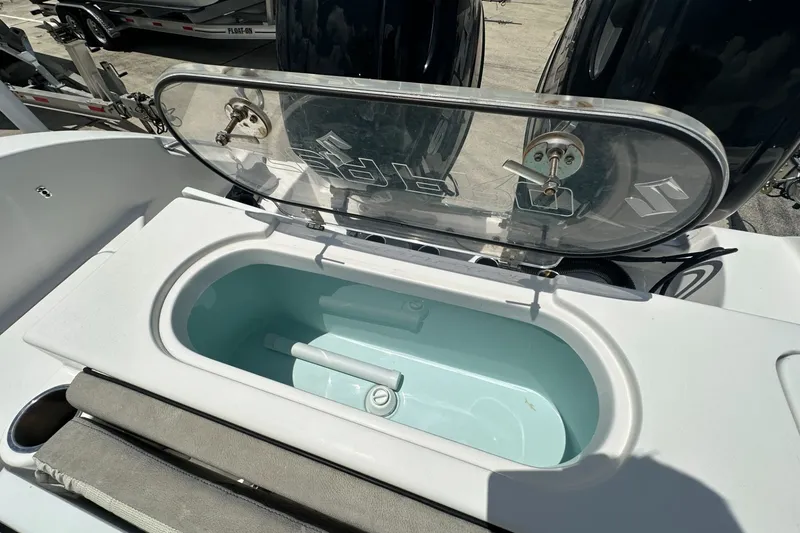 Slide: The Image of 2024 Sea Pro 262 Center Console livewell with open lid, showcasing interior features. - 19