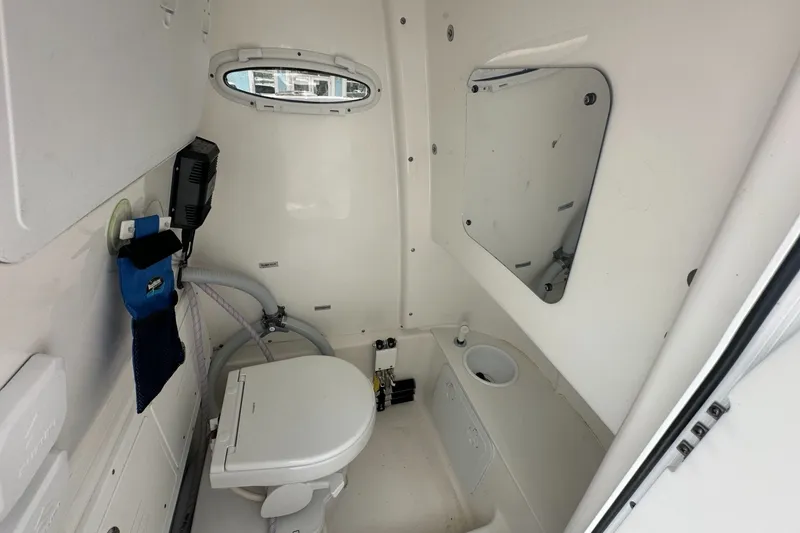 Slide: The Image of 2024 Sea Pro 262 Center Console boat interior with toilet and mirror. - 14