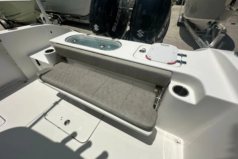 Slide: The Image of 2024 Sea Pro 262 Center Console boat interior with cushioned seating and storage compartments. - 18