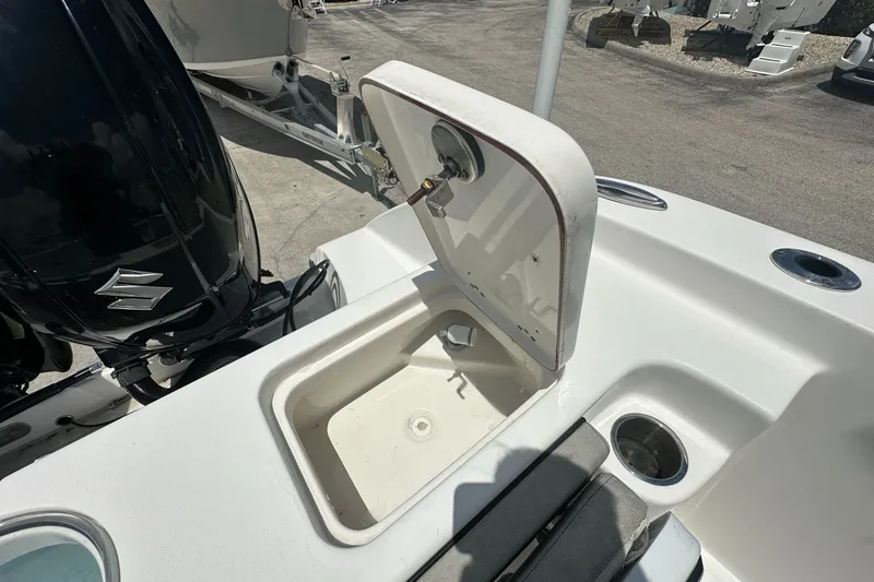 Slide: The Image of 2024 Sea Pro 262 Center Console boat with open storage compartment and Suzuki engine. - 20