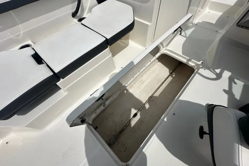 Slide: The Image of 2015 Sea Ray 21 SPX OB boat interior with open storage compartment. - 12