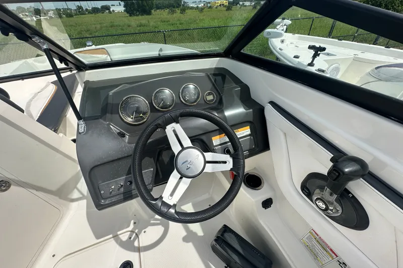 Slide: The Image of Steering console of a 2015 Sea Ray 21 SPX OB boat, featuring gauges and controls. - 7