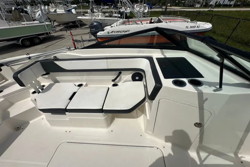 Slide: The Image of 2015 Sea Ray 21 SPX OB boat interior with seating and cup holders. - 9