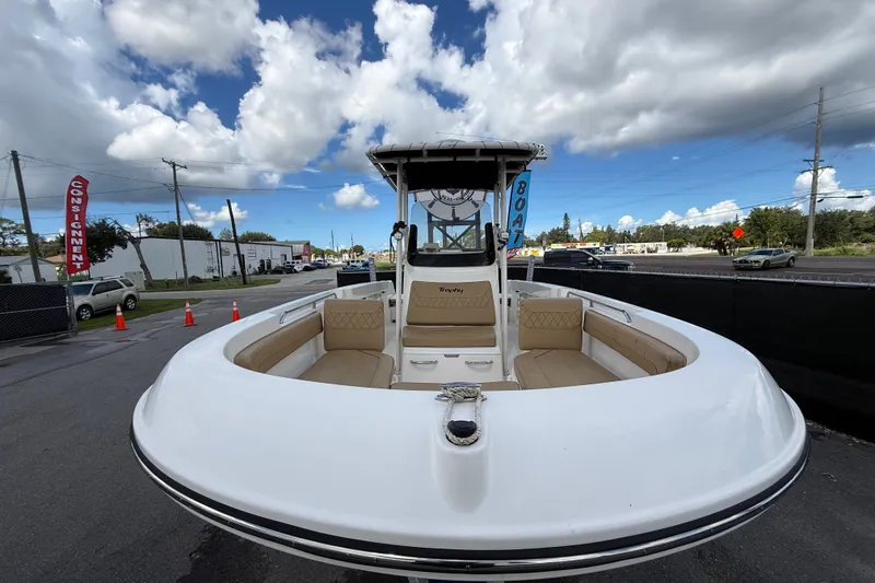 Slide: The Image of 2024 Bayliner Trophy T22CC boat with spacious seating, displayed outdoors under cloudy sky. - 12