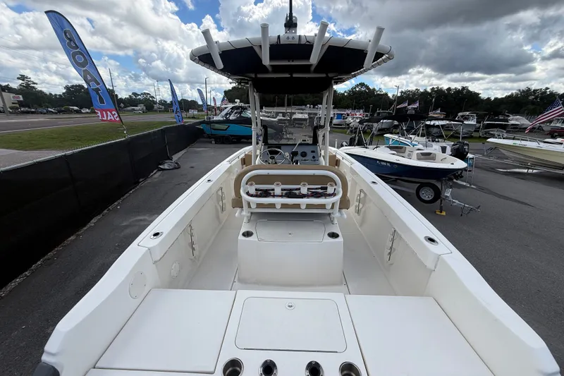 Slide: The Image of 2024 Bayliner Trophy T22CC boat on display at a dealership under cloudy skies. - 15