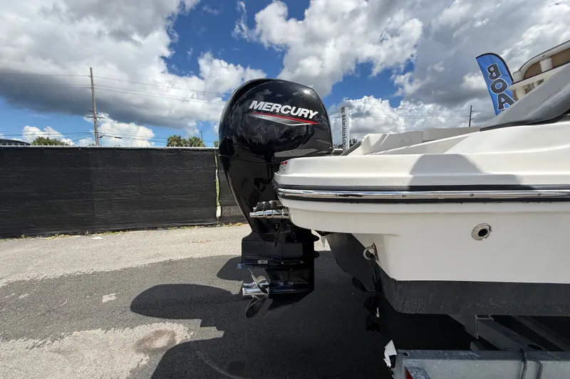 Slide: The Image of 2024 Bayliner Trophy T22CC with Mercury outboard motor under a cloudy sky. - 3