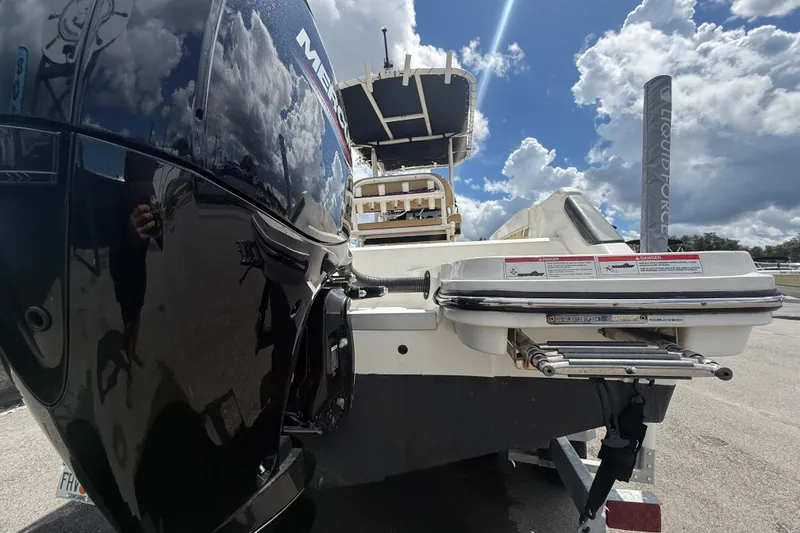 Slide: The Image of 2024 Bayliner Trophy T22CC boat rear view with Mercury engine and swim platform. - 4