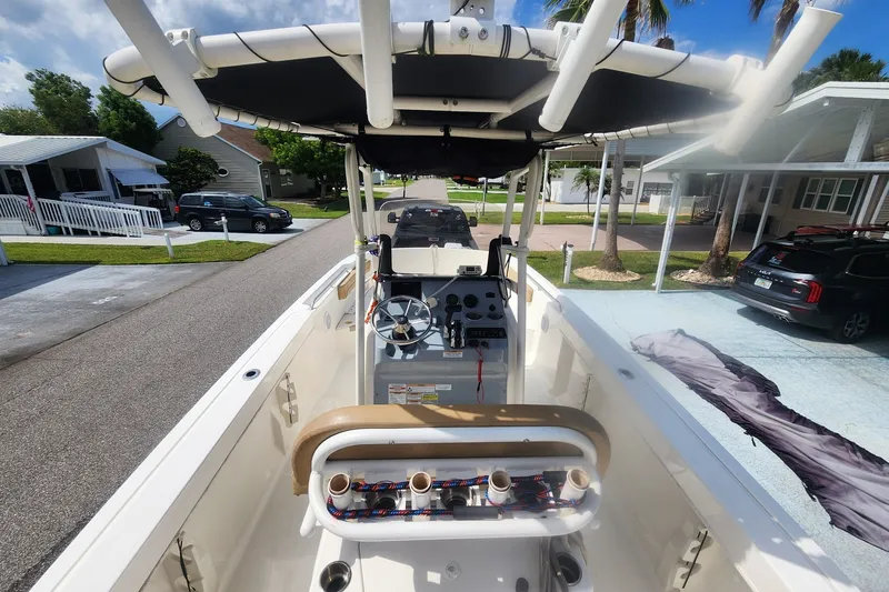 Slide: The Image of 2024 Bayliner Trophy T22CC boat interior with steering console and rod holders. - 4