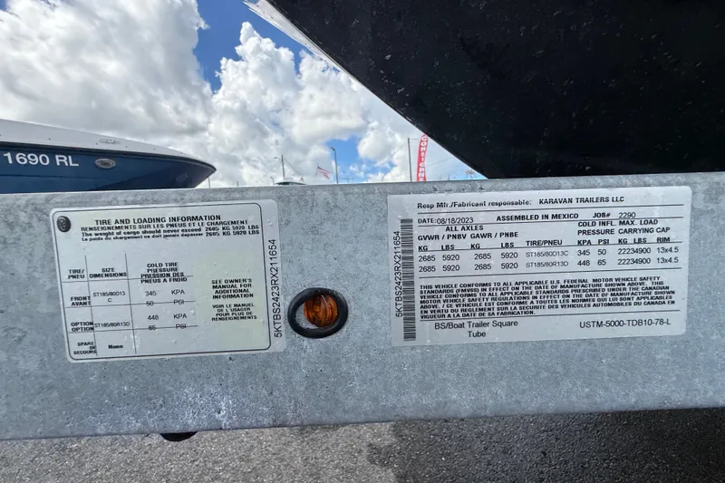 Slide: The Image of 2024 Bayliner Trophy T22CC trailer specifications and tire information labels. - 68