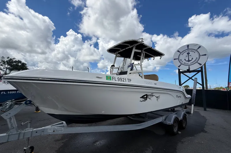 Slide: The Image of 2024 Bayliner Trophy T22CC boat on trailer under cloudy sky. - 11
