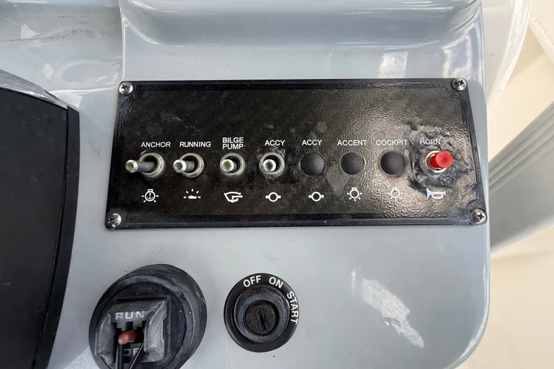 Slide: The Image of Control panel of 2024 Bayliner Trophy T22CC boat with switches and ignition. - 26
