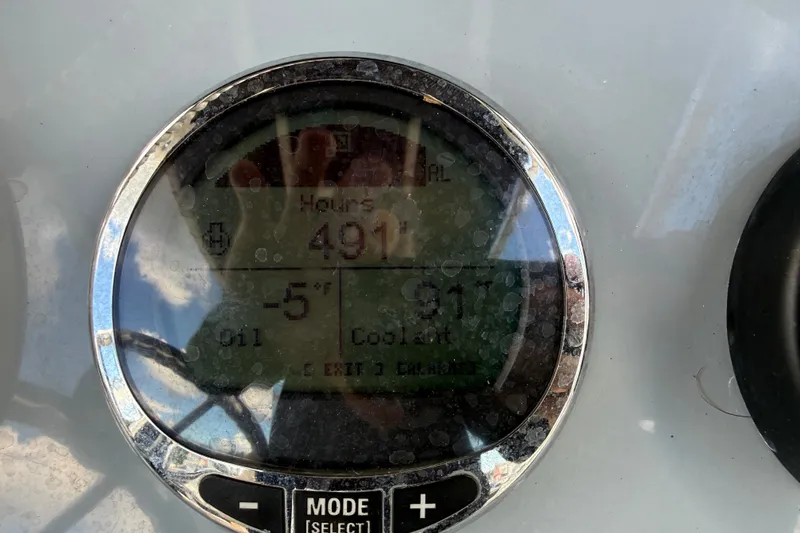 Slide: The Image of Dashboard display of 2024 Bayliner Trophy T22CC showing engine hours and temperature. - 28