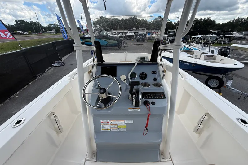 Slide: The Image of 2024 Bayliner Trophy T22CC boat console with steering wheel and controls. - 22