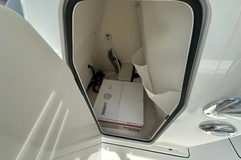 Slide: The Image of Storage compartment inside Avenger AV26 boat, featuring a box and wiring, 2027 model. - 16