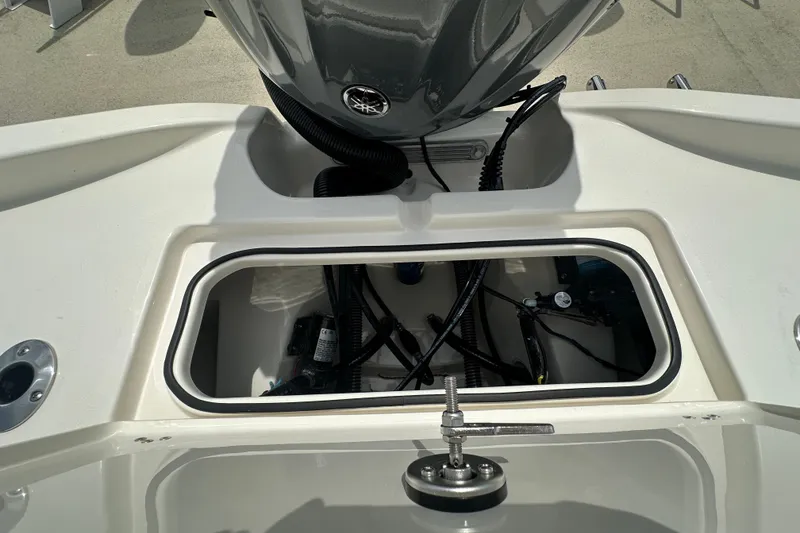 Slide: The Image of Open hatch of 2027 Avenger AV26 boat showing internal wiring and components. - 22