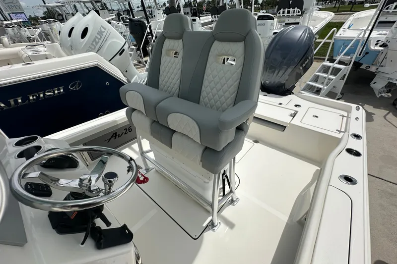 Slide: The Image of Luxury seating on 2027 Avenger AV26 boat with modern helm and controls. - 17