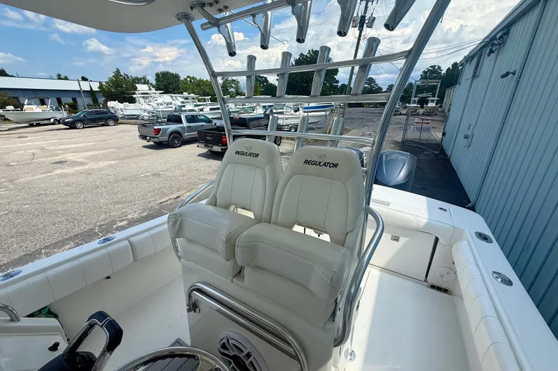 Slide: The Image of 2014 Regulator 28 Forward Seating boat with dual seats and rod holders. - 13