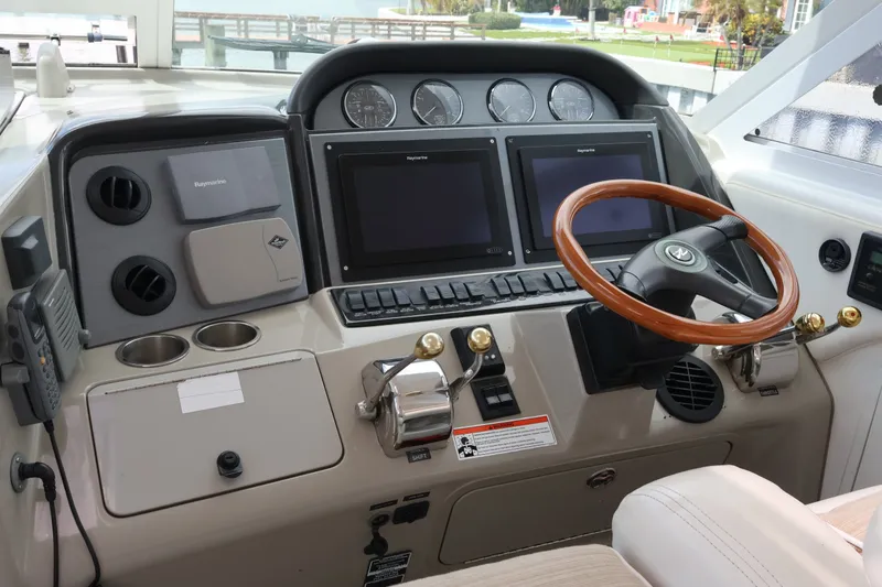 Slide: The Image of Helm of 2006 Sea Ray 40 Motor Yacht with dual screens and wooden steering wheel. - 32