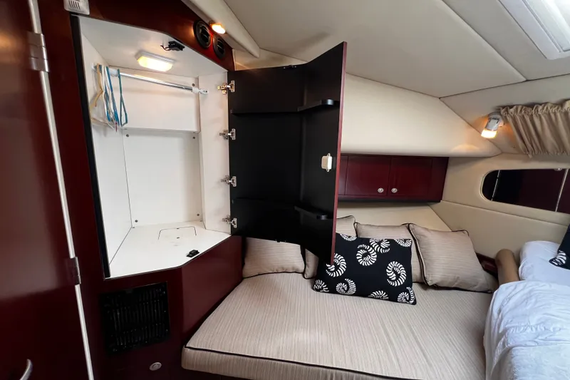 Slide: The Image of Interior of 2006 Sea Ray 40 Motor Yacht with open cabinet and cozy bedding. - 47