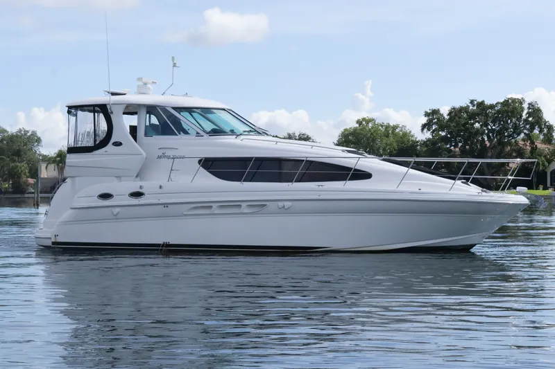 Slide: The Image of 2006 Sea Ray 40 Motor Yacht on calm water, showcasing sleek design and luxury features. - 1