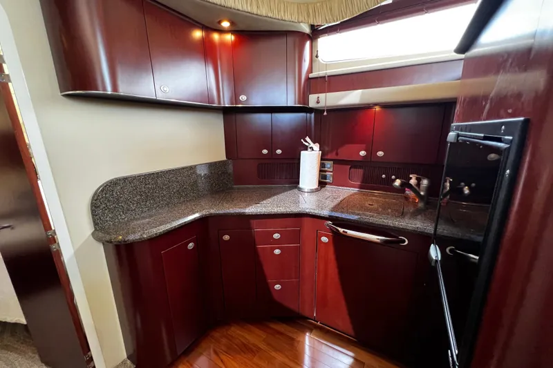 Slide: The Image of Luxurious kitchen interior of 2006 Sea Ray 40 Motor Yacht with sleek cabinetry and granite countertops. - 43