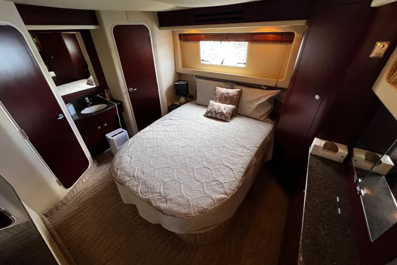 Slide: The Image of Luxurious bedroom interior of 2006 Sea Ray 40 Motor Yacht with elegant bedding and wood accents. - 50