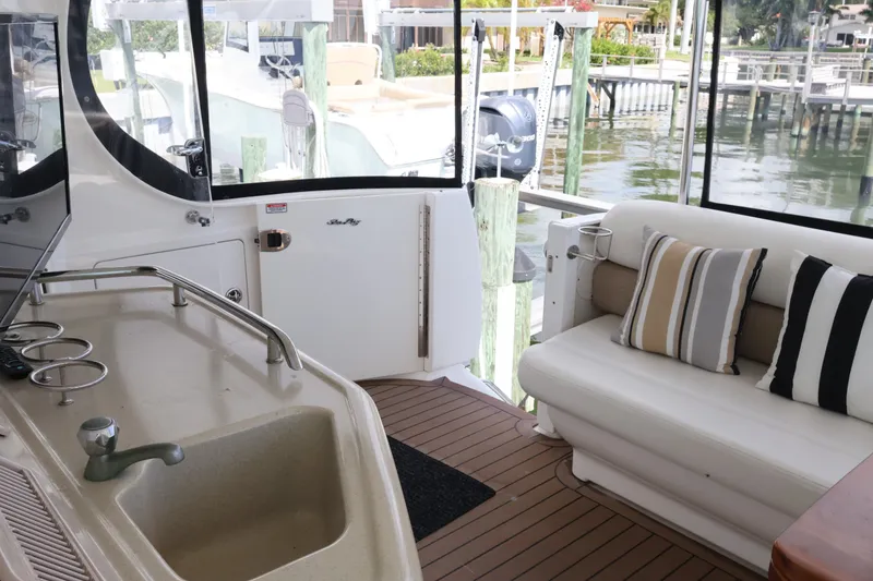 Slide: The Image of 2006 Sea Ray 40 Motor Yacht interior with seating, sink, and striped cushions. - 20
