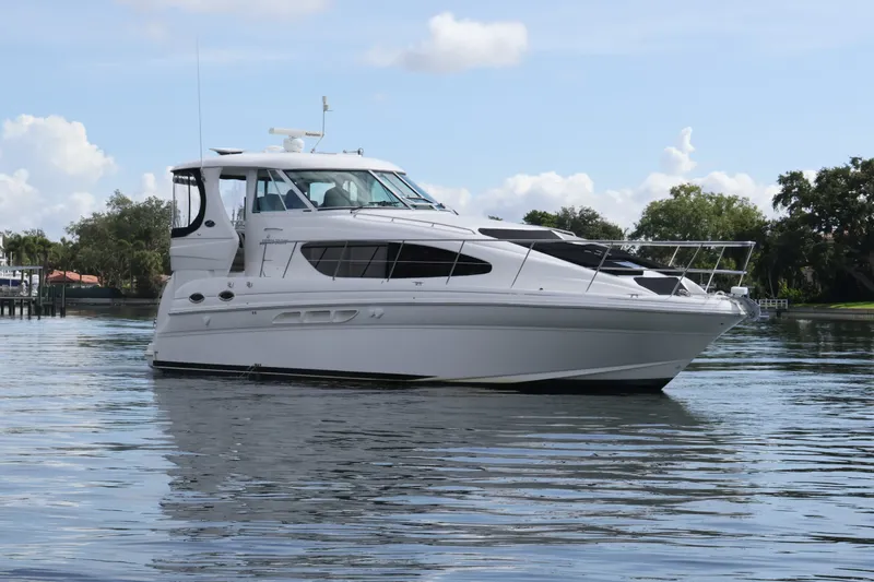 Slide: The Image of 2006 Sea Ray 40 Motor Yacht on calm water under blue sky. - 2