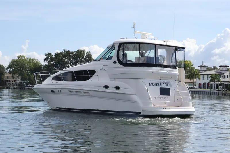 Slide: The Image of 2006 Sea Ray 40 Motor Yacht cruising on calm waters near waterfront homes. - 6