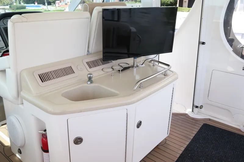 Slide: The Image of 2006 Sea Ray 40 Motor Yacht interior with sink, TV, and storage cabinets. - 23