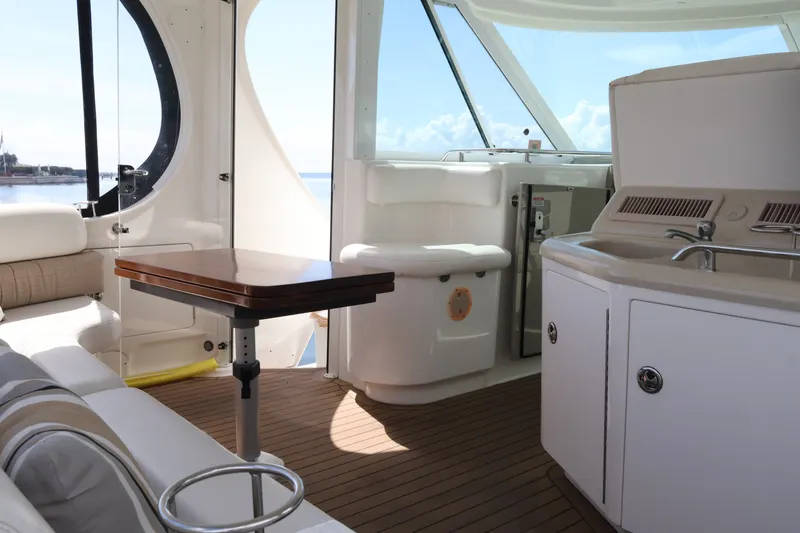 Slide: The Image of Interior of 2006 Sea Ray 40 Motor Yacht with seating, table, and kitchenette. - 21