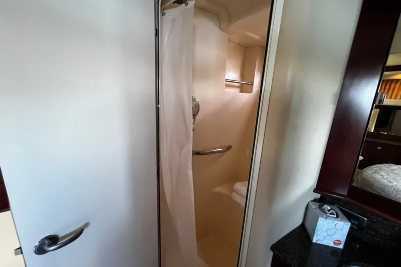 Slide: The Image of Shower area inside 2006 Sea Ray 40 Motor Yacht, featuring a curtain and towel rack. - 53