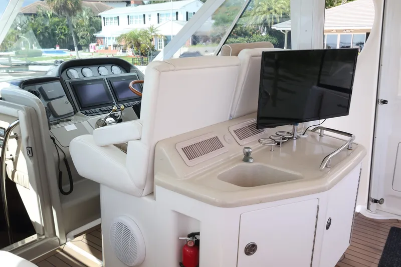 Slide: The Image of Interior of 2006 Sea Ray 40 Motor Yacht with helm, sink, and TV. - 22