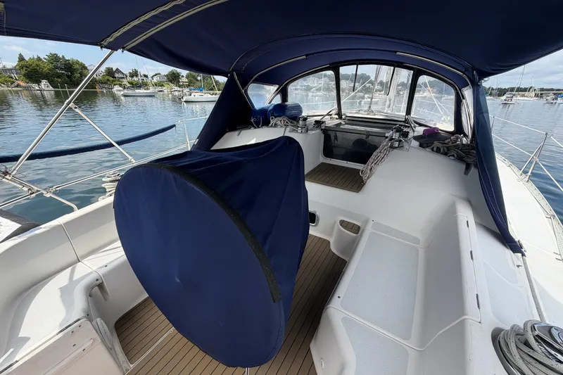 Slide: The Image of Cockpit of 1992 Hunter Legend 43 sailboat with blue canopy and marina view. - 10