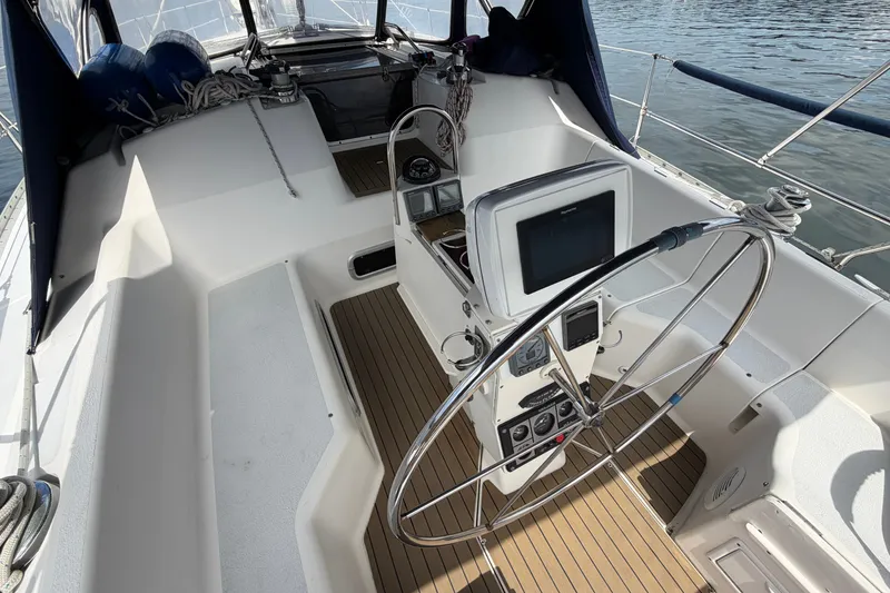 Slide: The Image of Cockpit of 1992 Hunter Legend 43 sailboat with steering wheel and navigation equipment. - 13